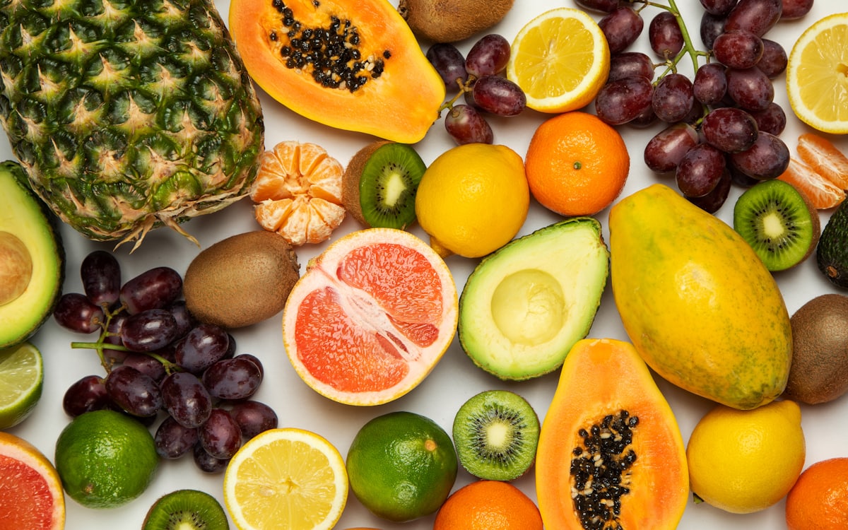 Fresh tropical produce — pineapple, papaya, and green avocado, representative of Yawed & Faroti's export catalog